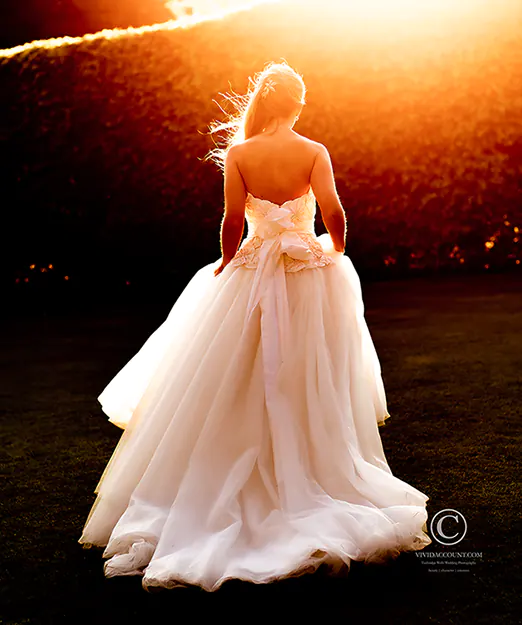 bride backlit by firery evening summer sun highlighting amazing hair styled by Tunbridge Wells wedding stylist