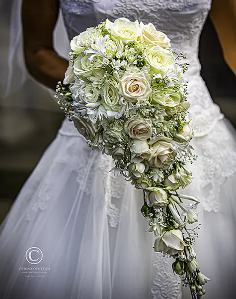 bespoke, elongated wedding bouquet in pastel shades of rose designed by Tunbridge Wells wedding florist