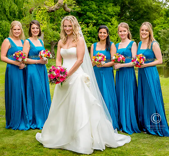 Bride and her five bridesmaids pose together at their Tunbridge Wells wedding venue for a semi formal wedding portrait