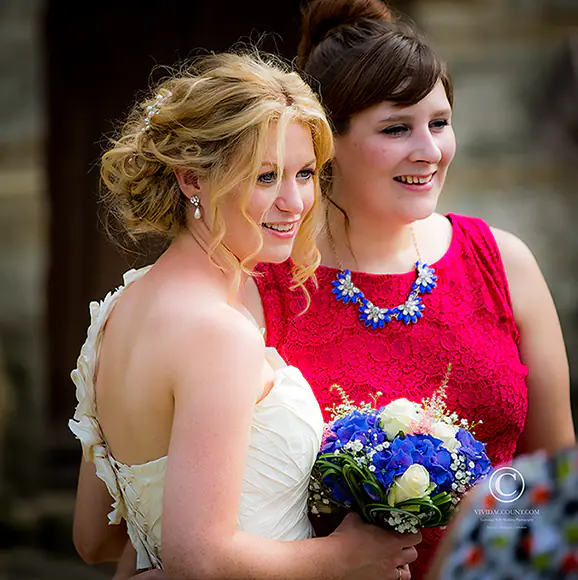 Bride chats to guest at Salomons Estate, Tunbridge Wells, Kent, during the wedding drinks reception on the terrace