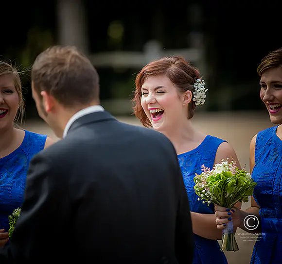 three bridesmaids seen bursting out in laughter as they wait with the groom near one warwick place ahead of the wedding at the tunbridge wells wedding venue