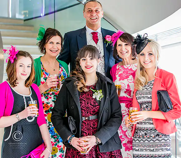 Groom and guests grouped together on the stairs of an exclusive wedding venue near Tunbridge Wells
