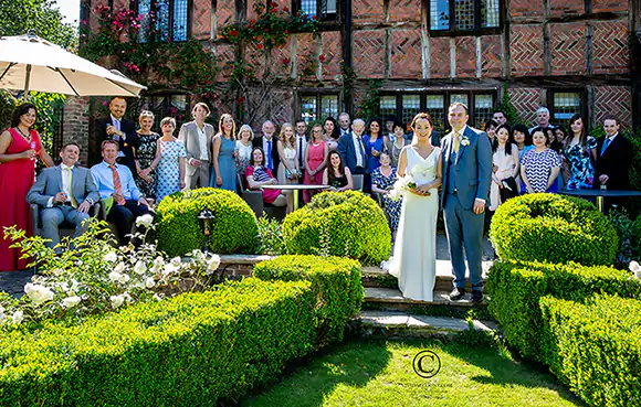 wedding guests arranged in garden of wooden beamed Tunbridge Wells house with bride and groom taking centre stage