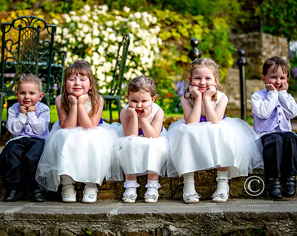 page boys and flower girls feigning frustration for an atmospheric group portrait at a Tunbridge Wells wedding venue