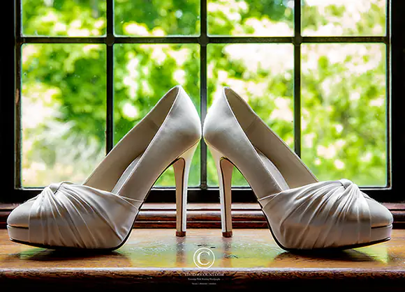 satin wedding shoes presents on hardwood window sill at Tunbridge Wells wedding venue