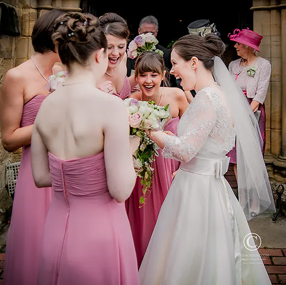 Bridesmaids see surpirse Bride was given during her wedding at a church in groombridge near Tunbridge Wells, Kent