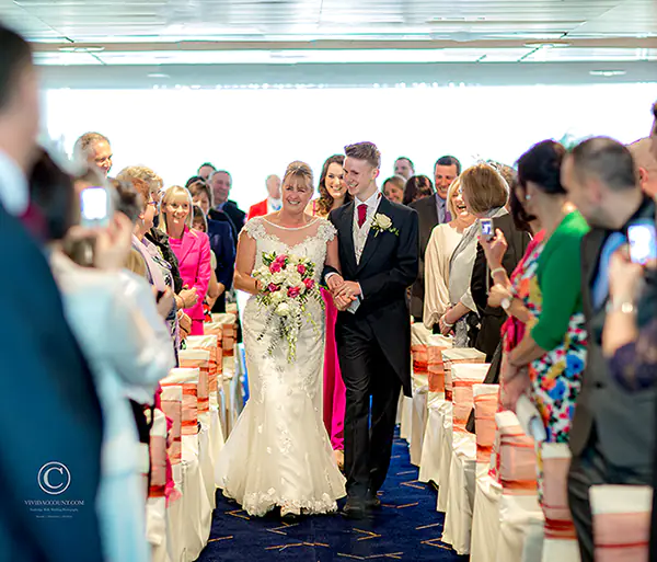 son escorts bride along the aisle to enable her wedding serive to commence