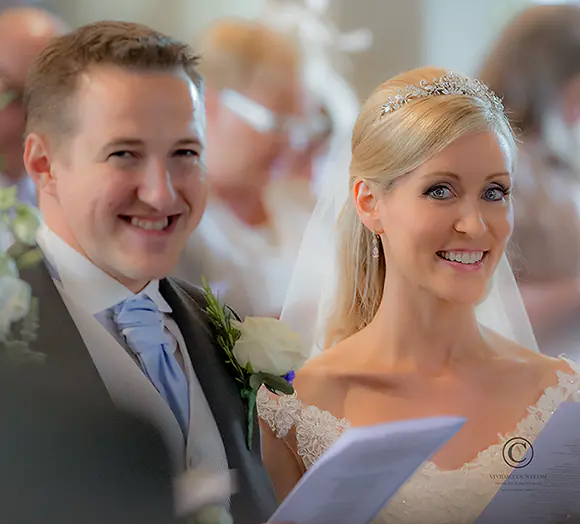 bride and groom singing hymns during their Tunbridge Wells church wedding service