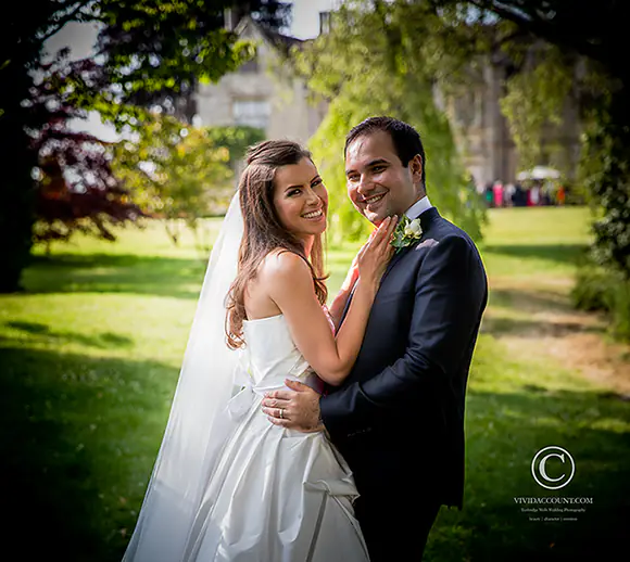 Wedding day smiles and cuddles for the bride and groom in the gardens at Wakehurst Place, near Tunbridge Wells