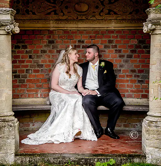 Bride and groom hide from the rain in a folly at their wedding venue near Tunbridge Wells