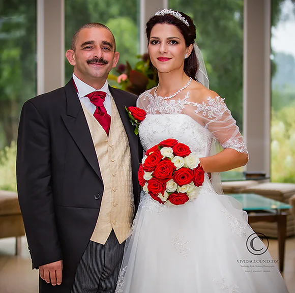 wedding portrait with bride holding red and white rose bouquet in the Orangery, Spa Hotel, Tunbridge kent, TN4
