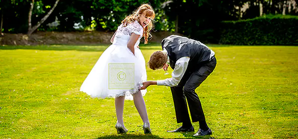 Groom helps bride as her Tunbridge Wells, Kent garter fails during wedding reception